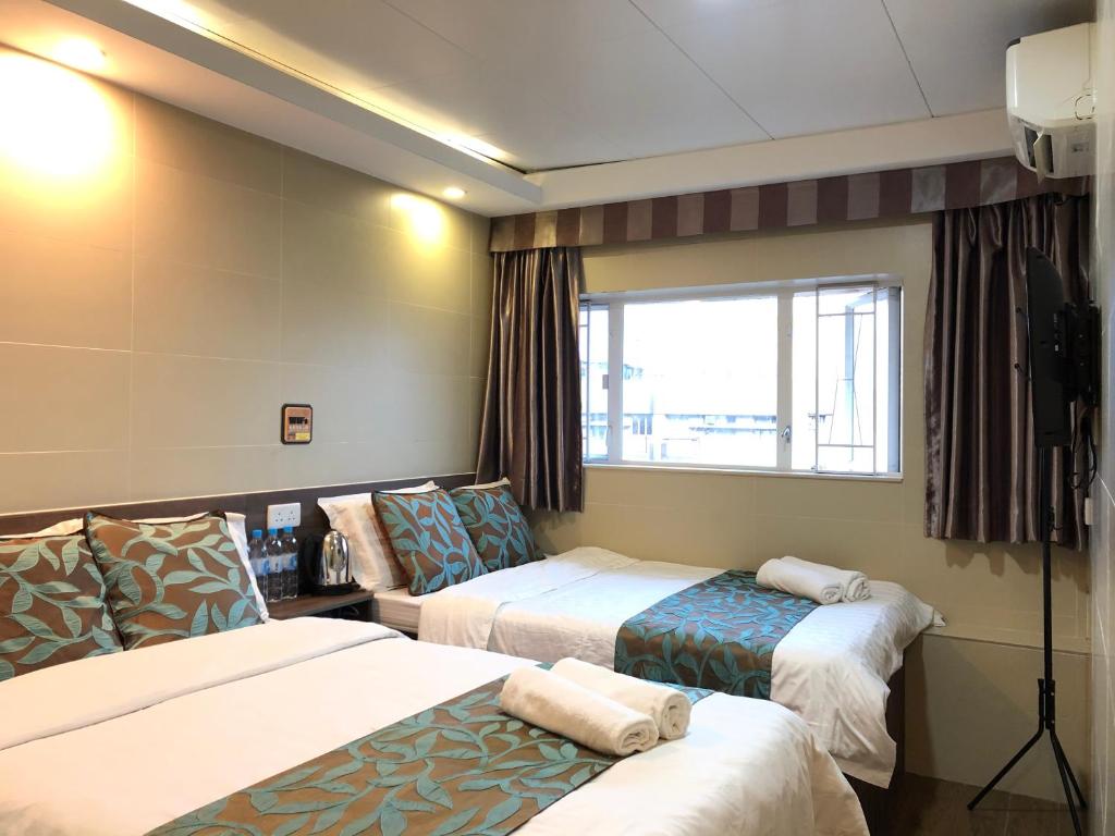 Posteľ alebo postele v izbe v ubytovaní 香港星星旅馆 b&b