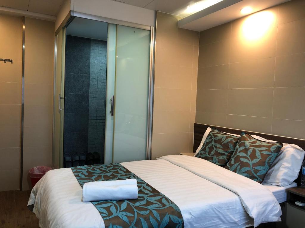 Postel nebo postele na pokoji v ubytování 香港星星旅馆 2202 Guesthouse