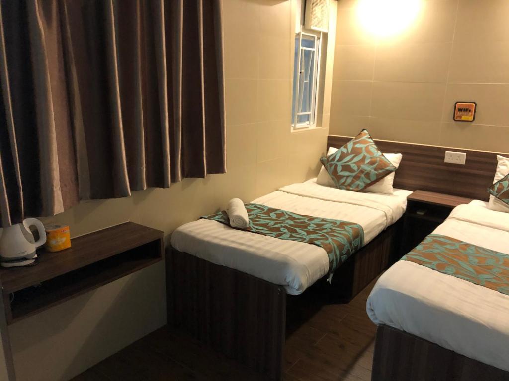 Postel nebo postele na pokoji v ubytování 香港星星旅馆 2202 Guesthouse
