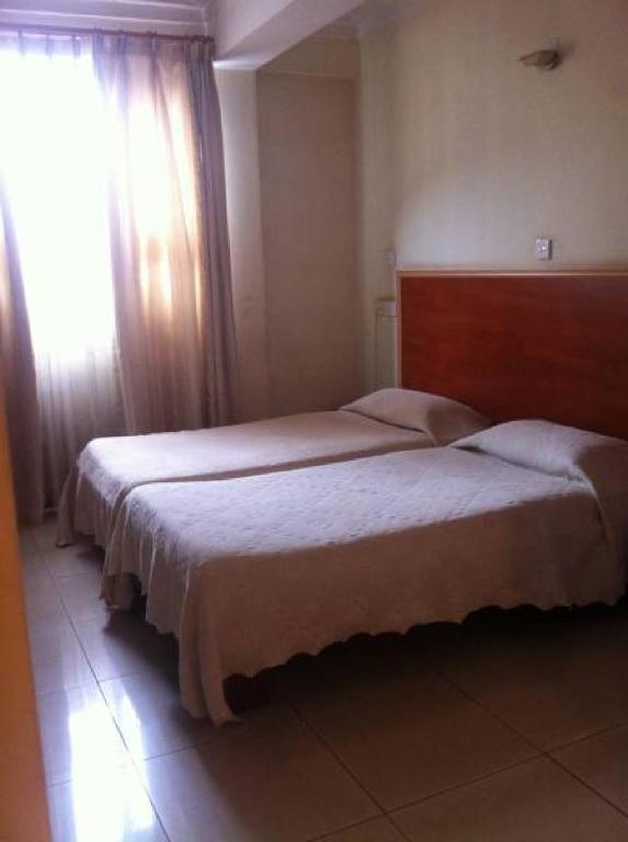 Postel nebo postele na pokoji v ubytování Ivys Hotel