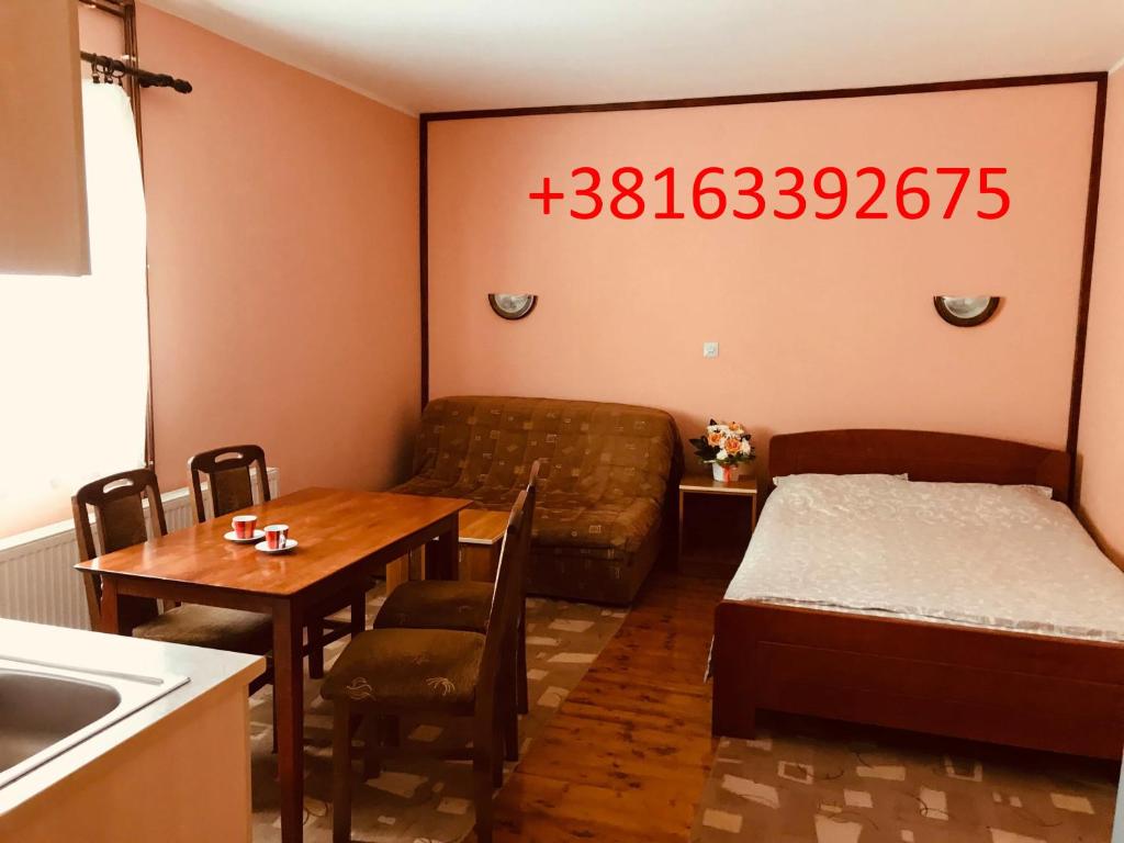a living room with a couch and a table and a bed at Apartments Vukomanović in Zlatibor