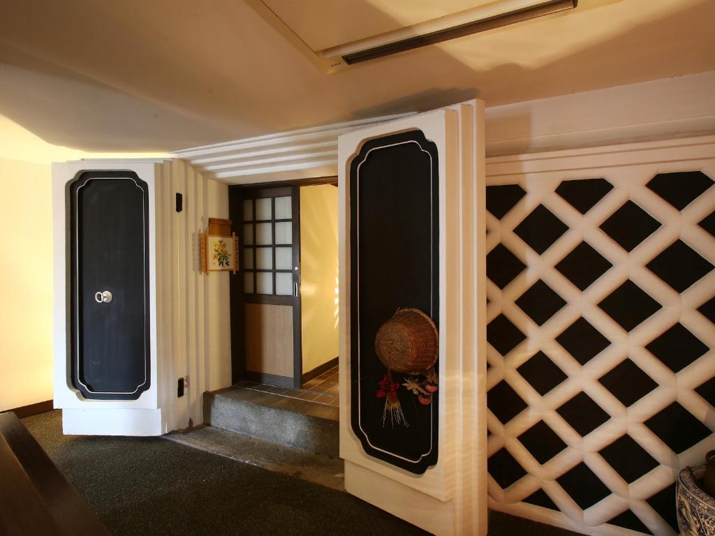 a room with a wine cellar with a wall at Kisoji no Yado Iwaya in Kiso