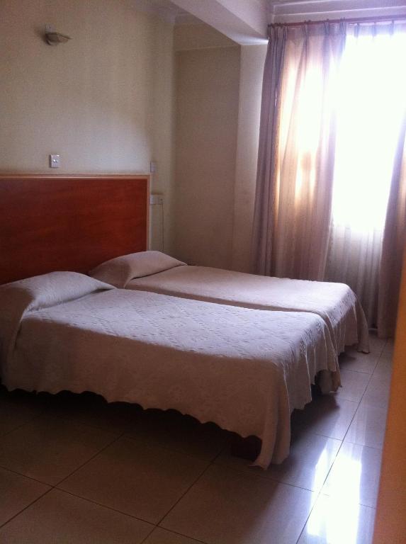 Postel nebo postele na pokoji v ubytování Ivys Hotel