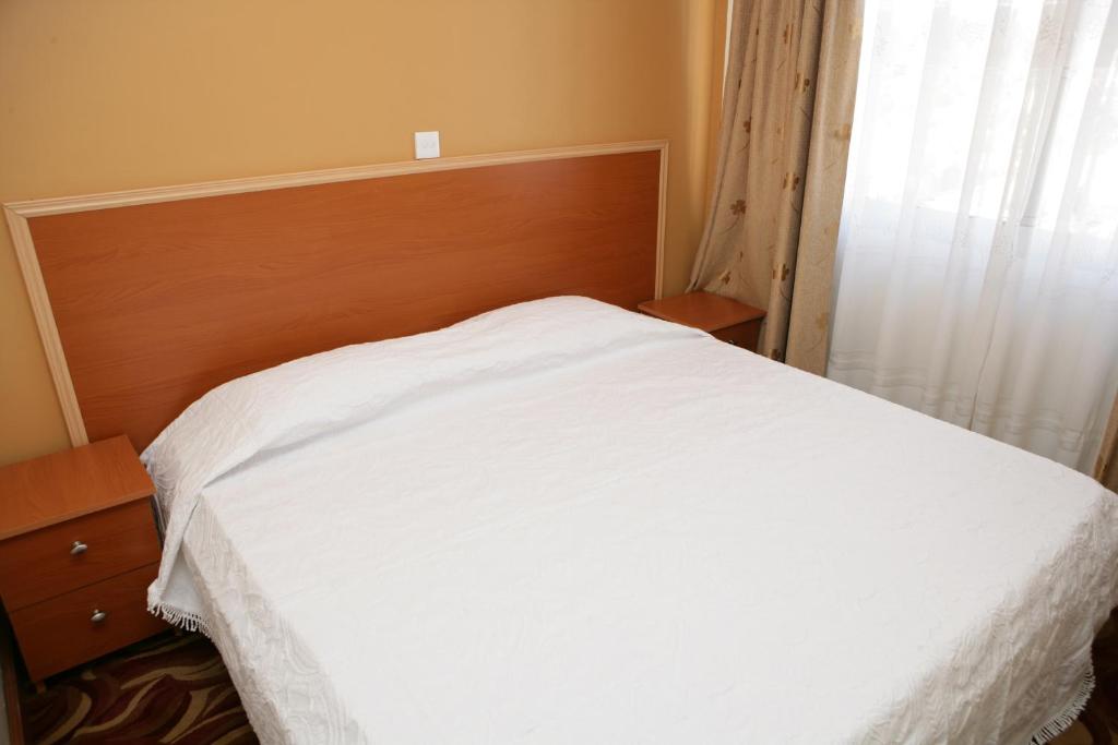 Postel nebo postele na pokoji v ubytování Ivys Hotel