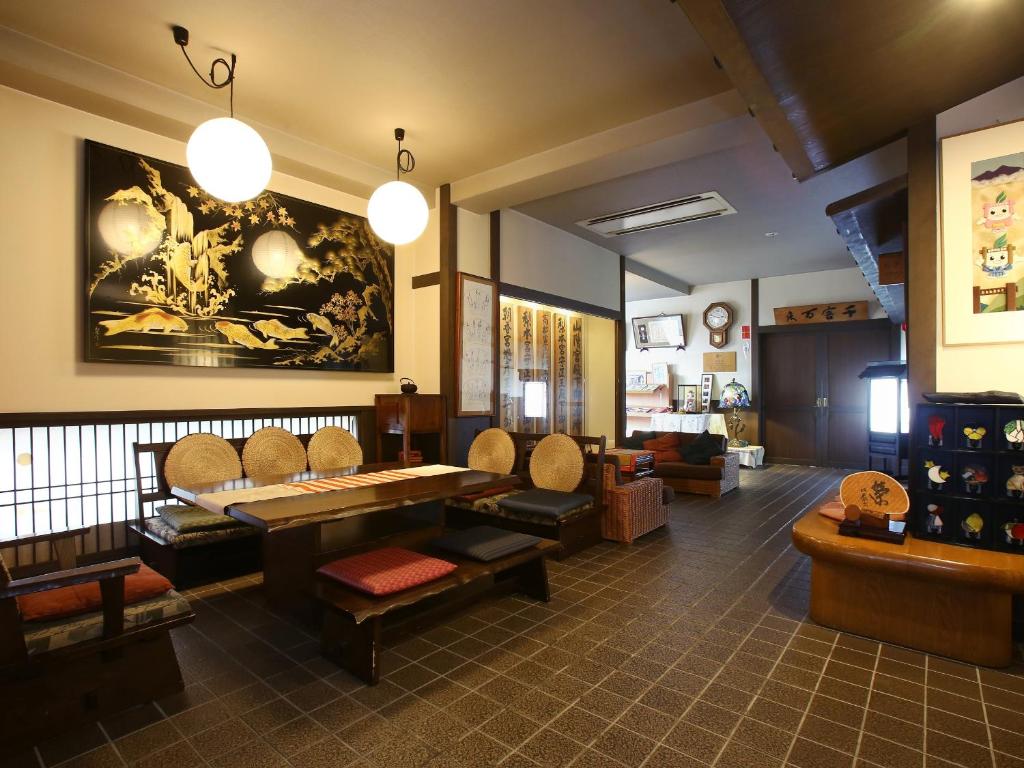 a waiting room with chairs and a table in a room at Kisoji no Yado Iwaya in Kiso