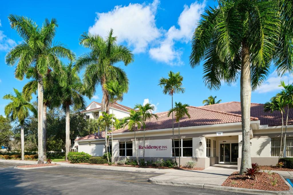 a building with palm trees in front of it at Residence Inn by Marriott Fort Lauderdale City of Plantation in Plantation