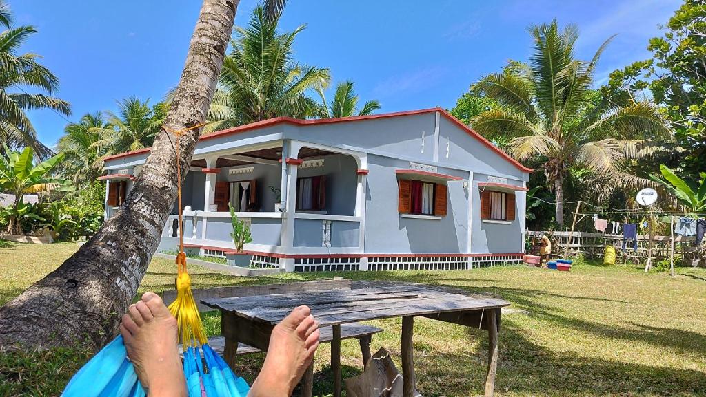 a person in a hammock in front of a house at Villa Ste Marie in Sainte Marie