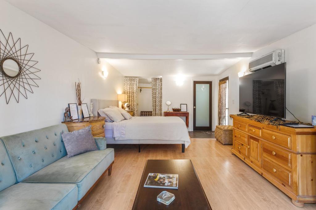 a living room with a bed and a couch at Private Studio City Guest House in Los Angeles