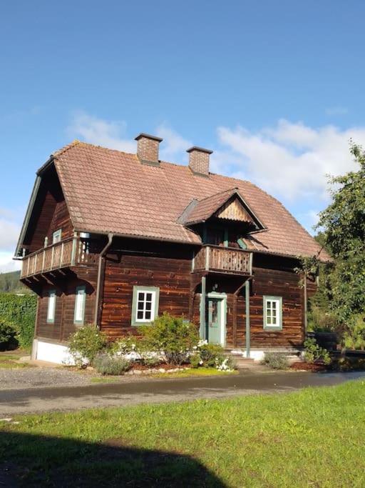 a large wooden house with a roof at Ferienhaus Schlossbauer in Spielberg