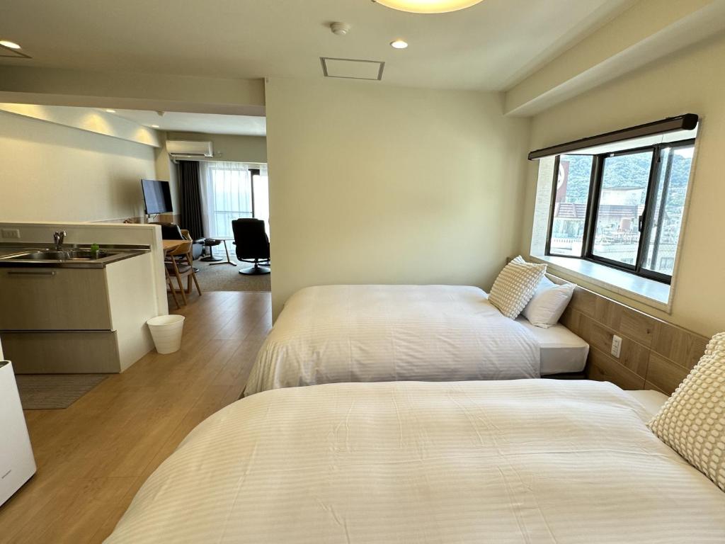 Postel nebo postele na pokoji v ubytování Grandview Atami Private Hot Spring Condominium Hotel
