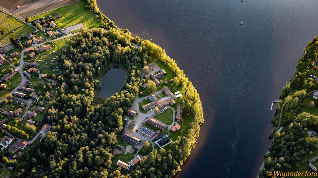 an aerial view of a forest next to a lake at Leksands Folkhögskola in Leksand