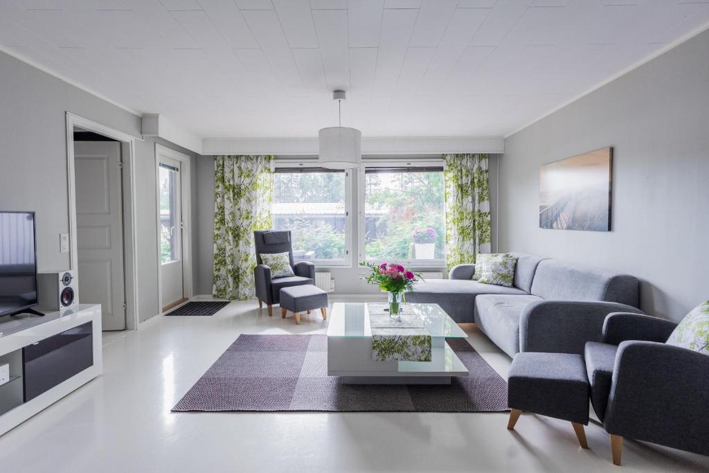 a living room with a couch and a table at Arctic Holiday Apartments 3 in Rovaniemi
