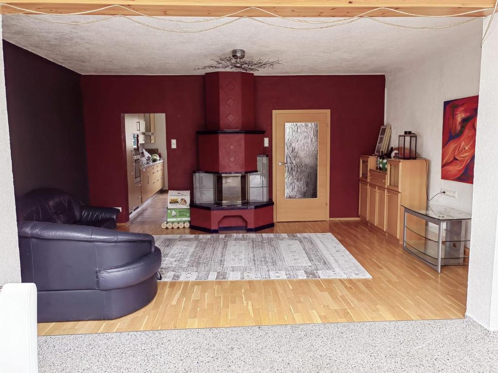 a living room with purple walls and a couch at Ferienhaus Emi 