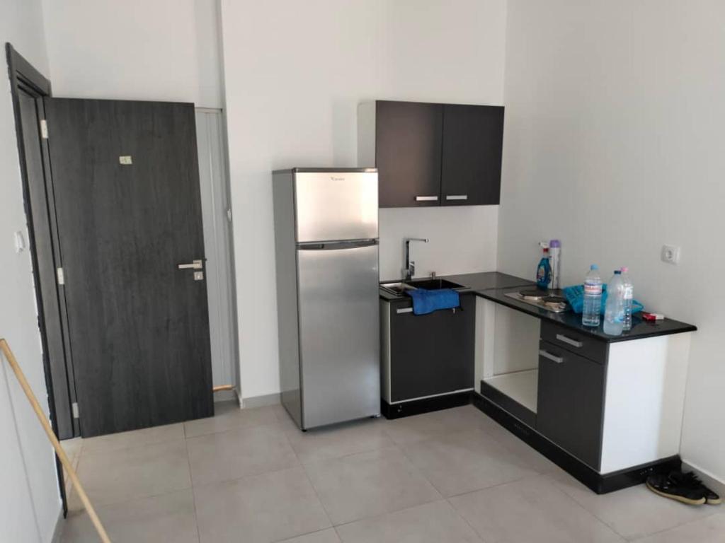 a kitchen with a refrigerator and a counter top at Golden GbS in Skikda