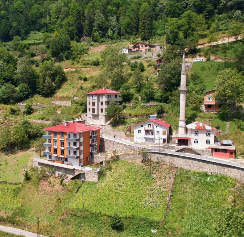 a group of buildings on a hill with a train at Sağlam Apart Otel in Uzungol