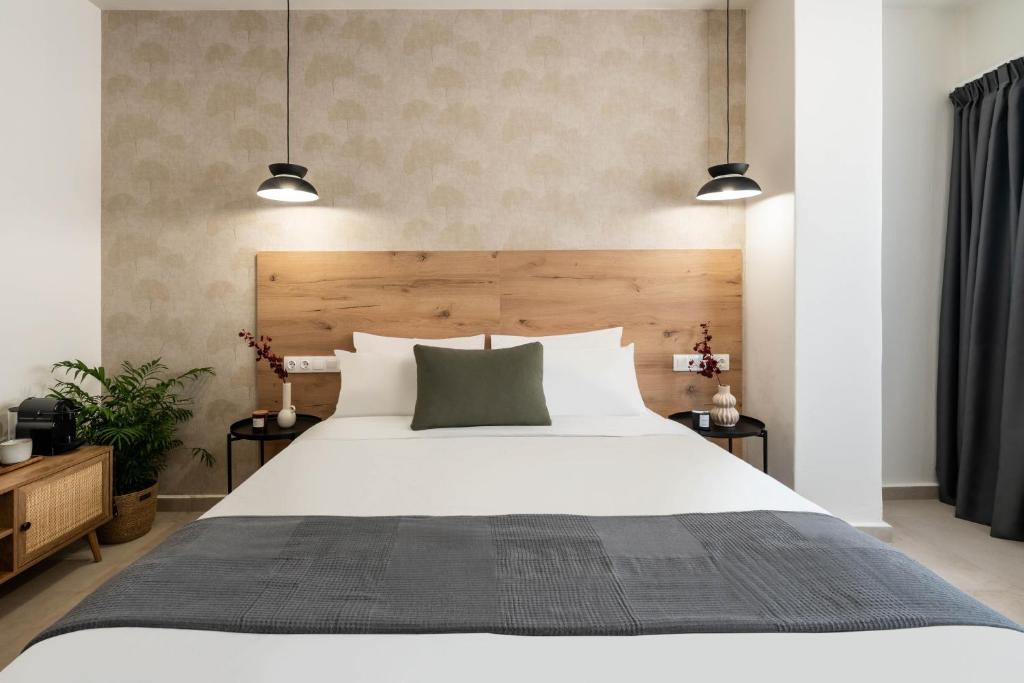 a bedroom with a large white bed with two lamps at KOYO Athens in Athens