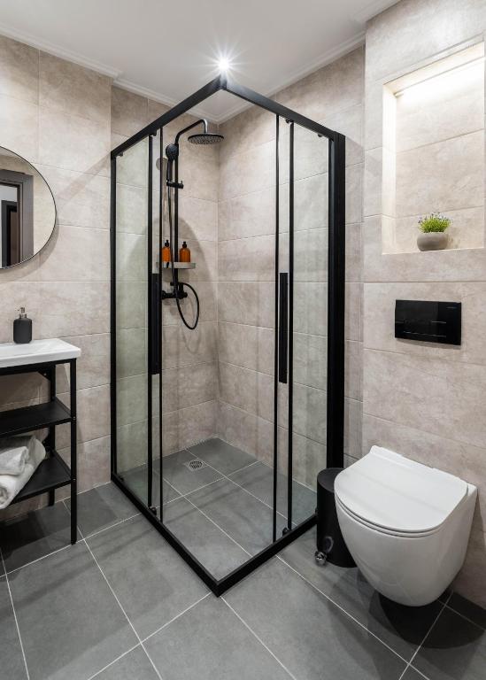 a bathroom with a shower with a toilet and a sink at KOYO Athens in Athens