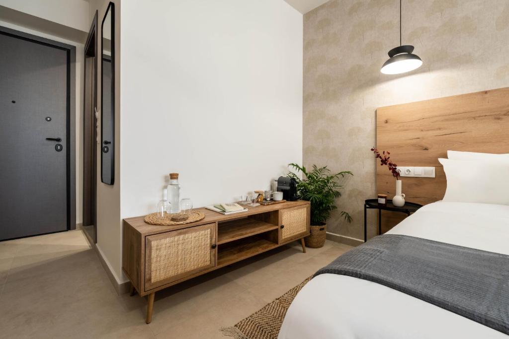 a bedroom with a bed and a wooden cabinet at KOYO Athens in Athens