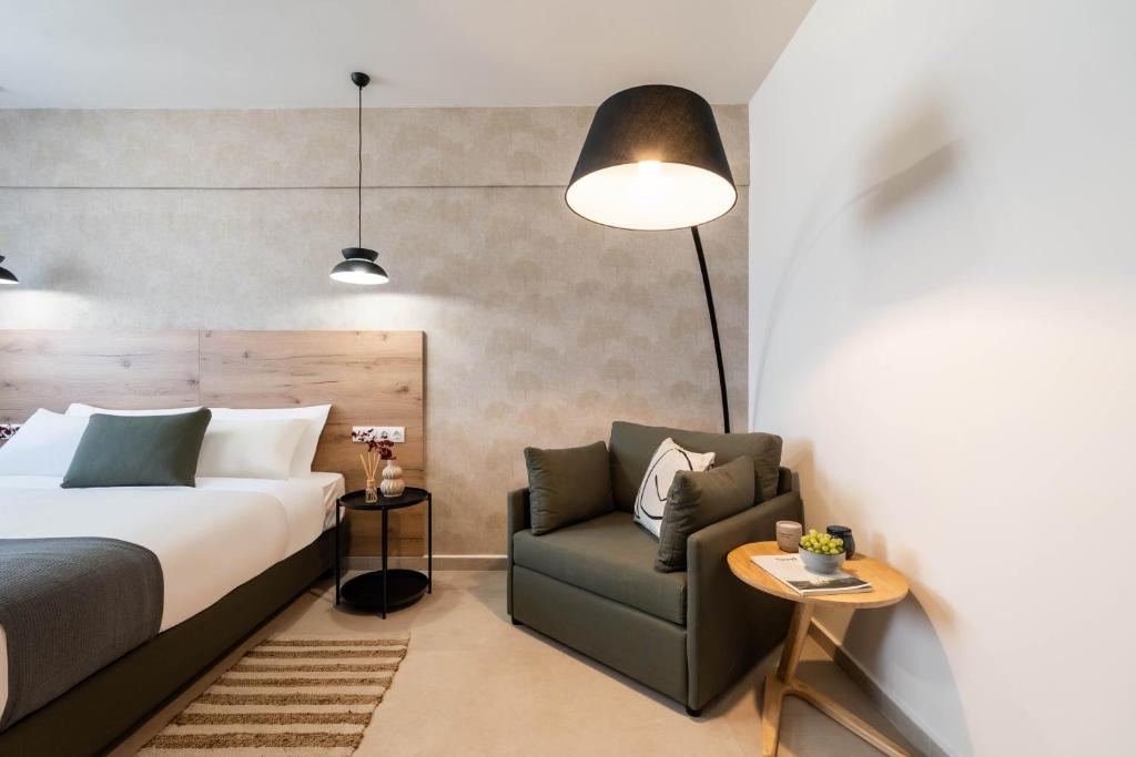 a hotel room with a bed and a chair at KOYO Athens in Athens