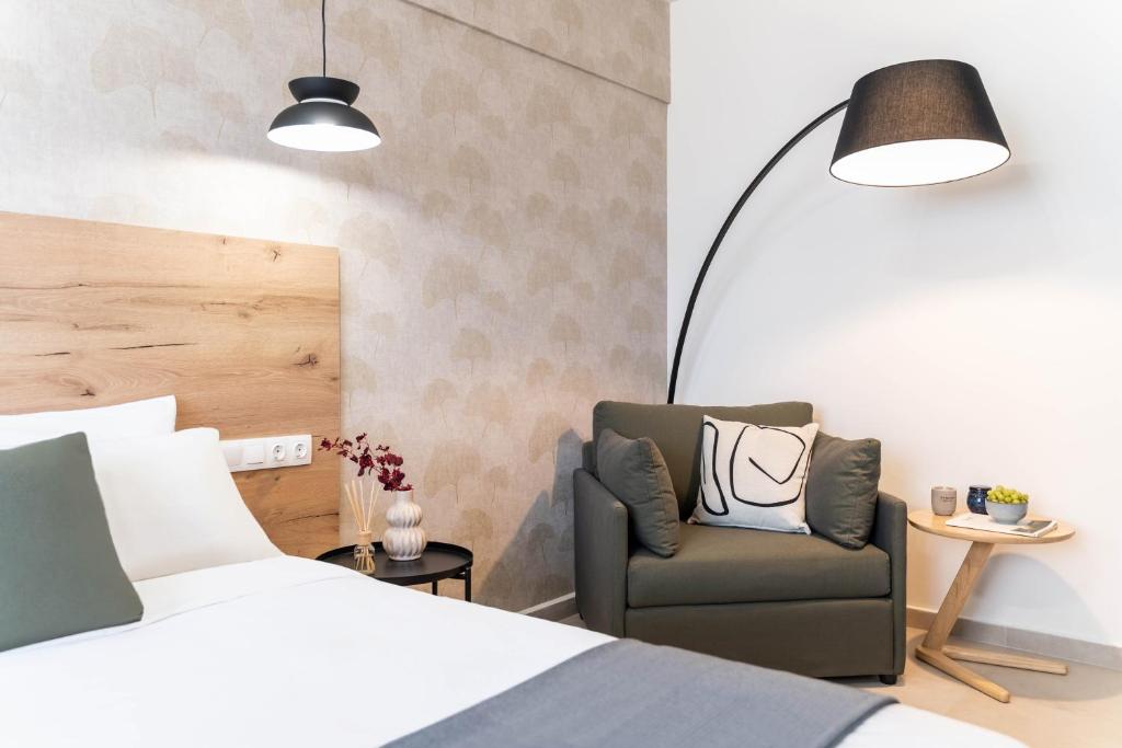 a bedroom with a bed and a chair and a lamp at KOYO Athens in Athens