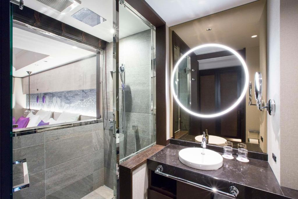 a bathroom with a sink and a mirror at Dhawa Yura Kyoto - Banyan Group in Kyoto