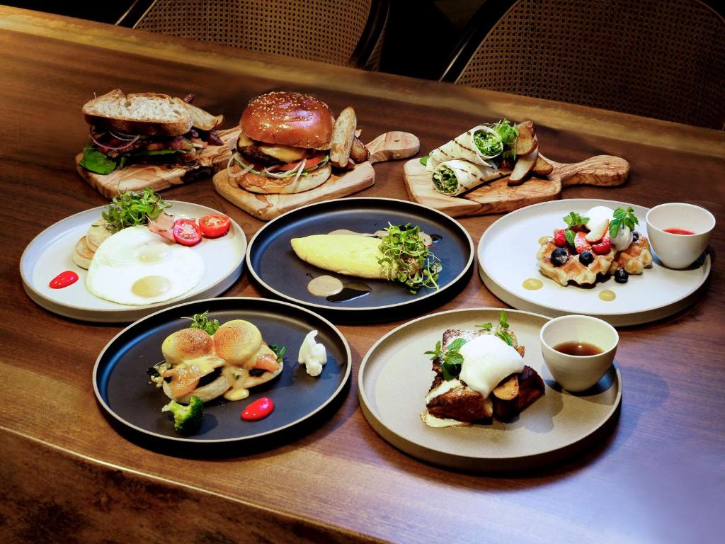 a wooden table with plates of food on it at Dhawa Yura Kyoto - Banyan Group in Kyoto