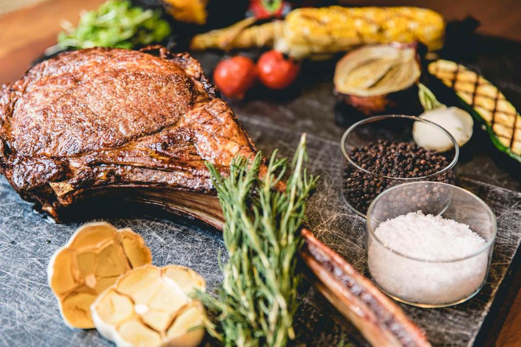 a plate with a steak and vegetables on a table at Dhawa Yura Kyoto - Banyan Group in Kyoto