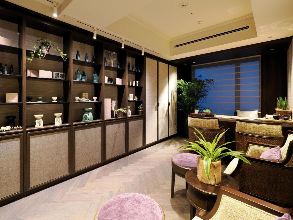 a restaurant with a table and chairs and a counter at Dhawa Yura Kyoto - Banyan Group in Kyoto