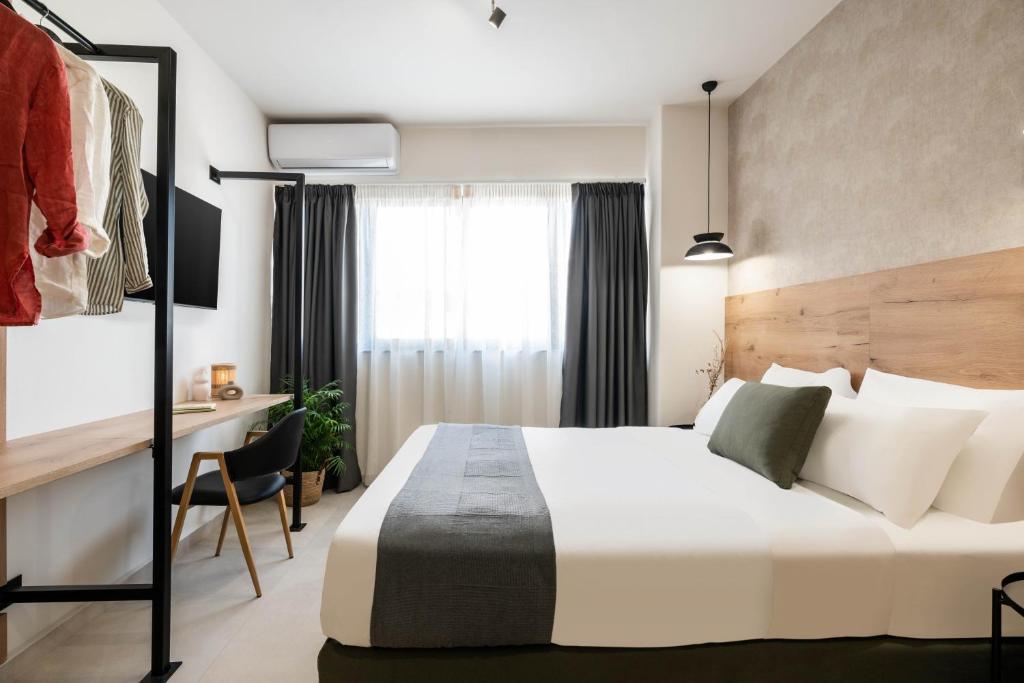 a hotel room with a bed and a desk at KOYO Athens in Athens