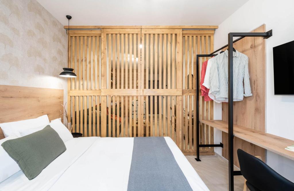 a bedroom with a bed and a tv in a room at KOYO Athens in Athens