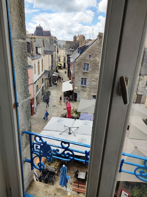 a view from a window of a street with a clock at le panoramique in Quimper