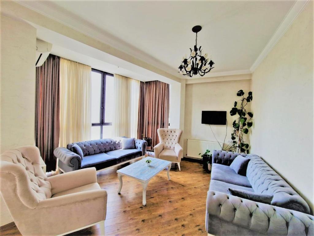 un soggiorno con due divani e un tavolo di 3 Bedroom 2 Bathroom Apartment on Saburtalo Gagarin a Tbilisi City
