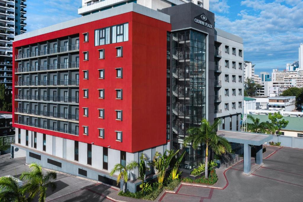 a red building in front of a white building at Crowne Plaza - Dar Es Salaam, an IHG Hotel in Dar es Salaam