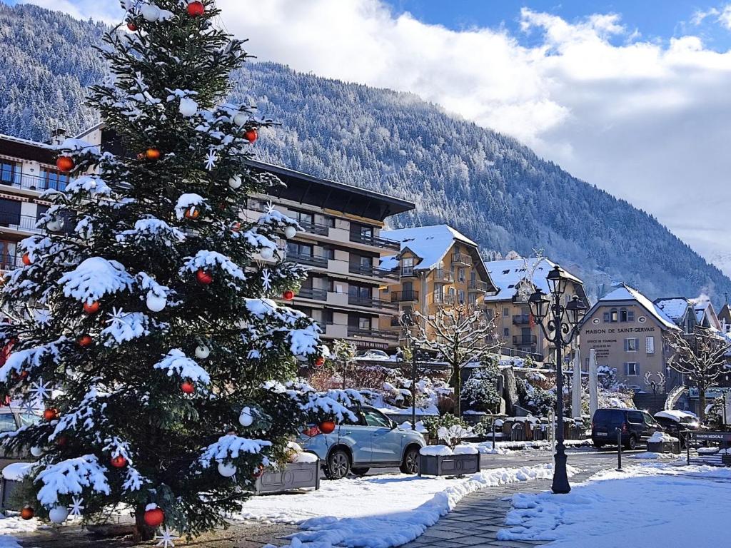 a christmas tree in a parking lot with snow on it at Studio La Royale by Interhome in Saint-Gervais-les-Bains