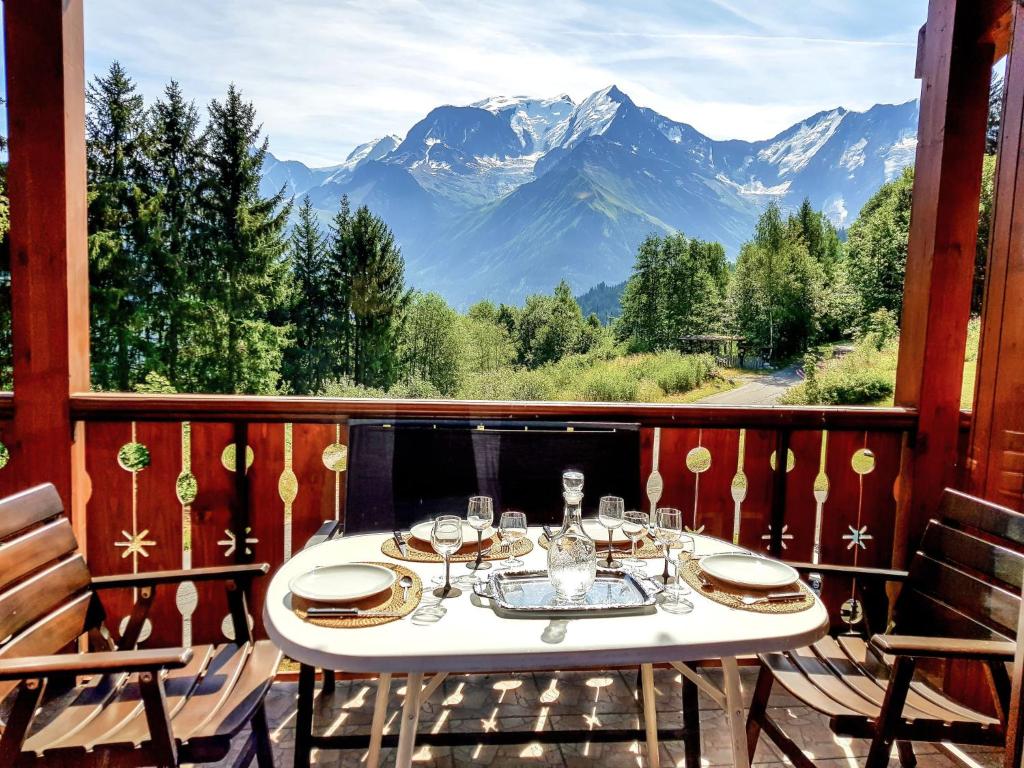 a table on a balcony with a view of mountains at Apartment Le Tagre by Interhome in Mémontel