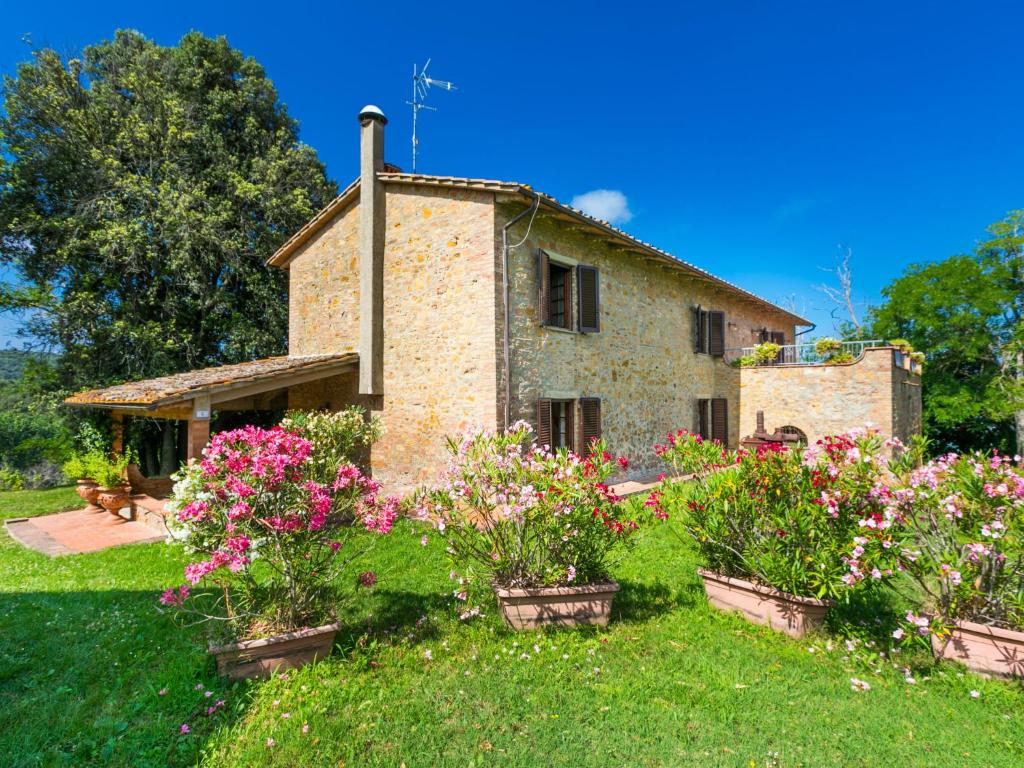 an old stone house with flowers in front of it at Holiday Home Poggio al Colle by Interhome in San Vivaldo