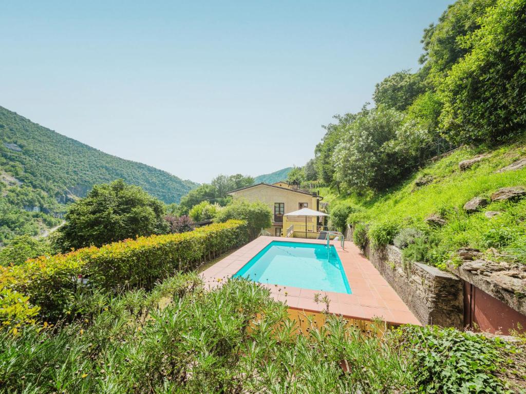 a house with a swimming pool in a hillside at Holiday Home La Grande Aia by Interhome in Seravezza