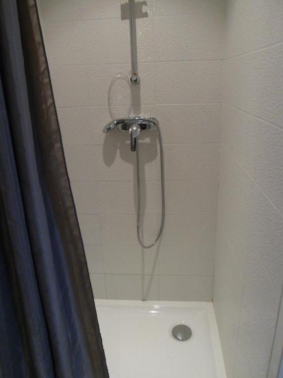 a shower with a shower head in a bathroom at Hotel du Cap in Cap-Ferret