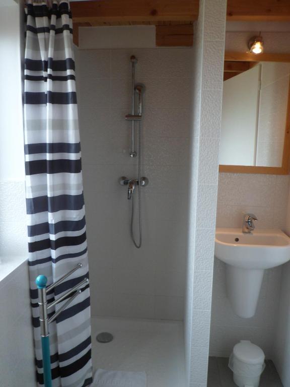 a bathroom with a shower and a sink at Hotel du Cap in Cap-Ferret