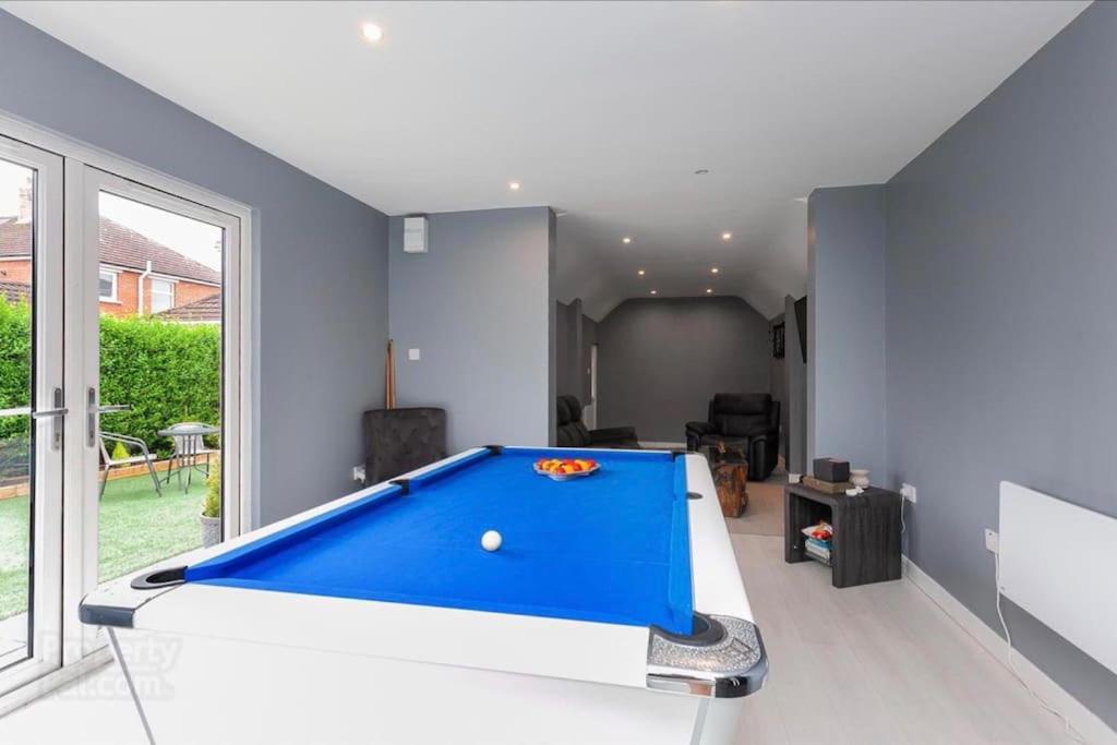 a living room with a large blue pool table at Modern home 10 mins to Belfast City in Belfast