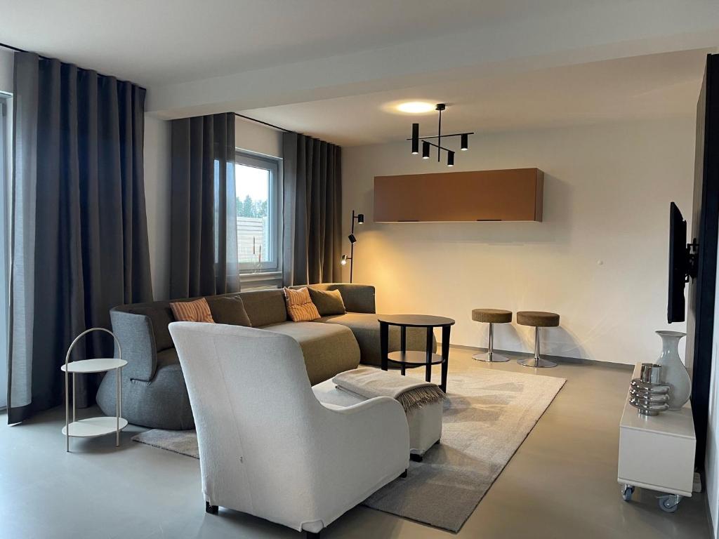 a living room with a couch and a table at CASA LOBO Charmantes Ferienhaus im Allgäu in Leutkirch im Allgäu