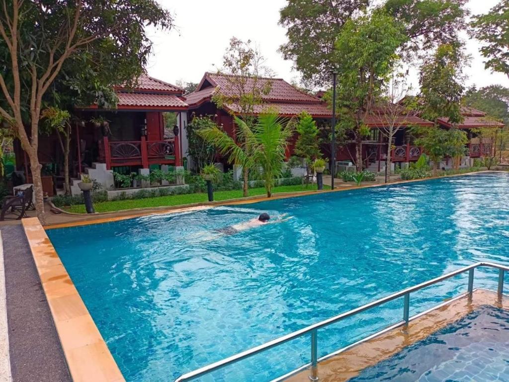 a swimming pool in front of a house at Country Cafe & Camping in Ban Cha-om