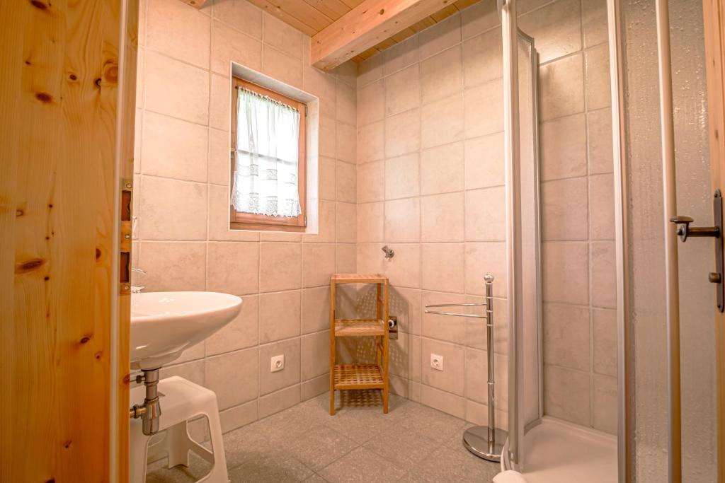 a bathroom with a sink and a shower at Alpin-Hütten auf der Turracherhöhe Haus Murmeltier by S4Y in Turracher Hohe