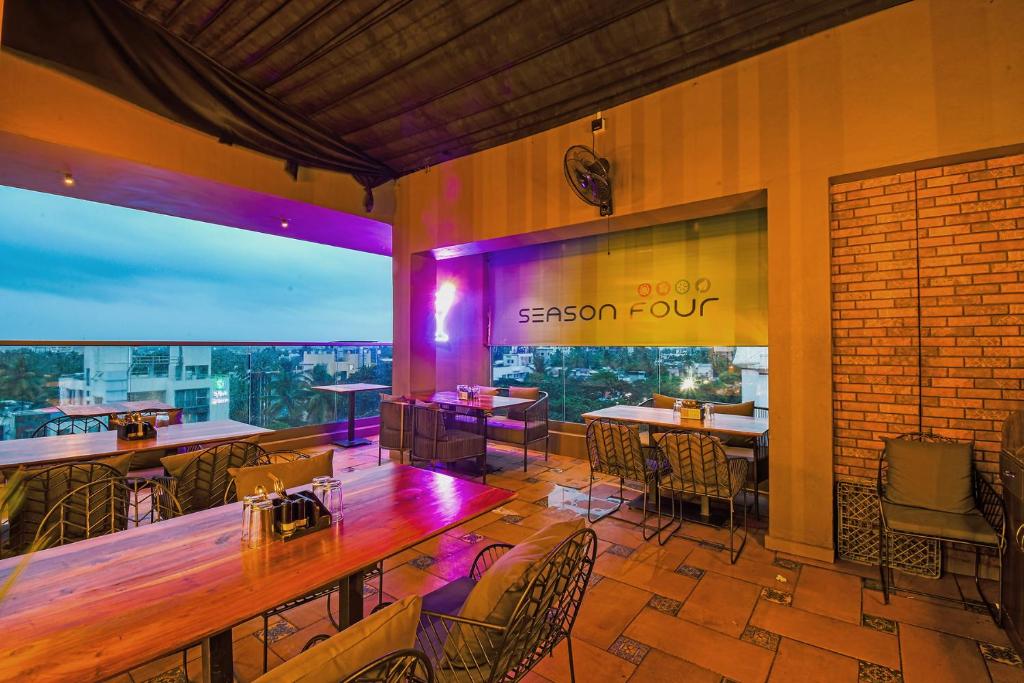 a restaurant with tables and chairs and a view at Hotel Season 4 -3-star hotel in Sāngli