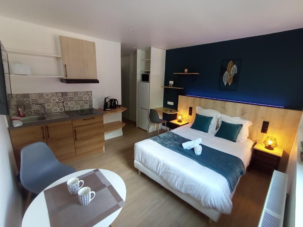a bedroom with a large bed with a blue wall at Villa Raphaëlle #1 Centre ville avec parking in Le Havre