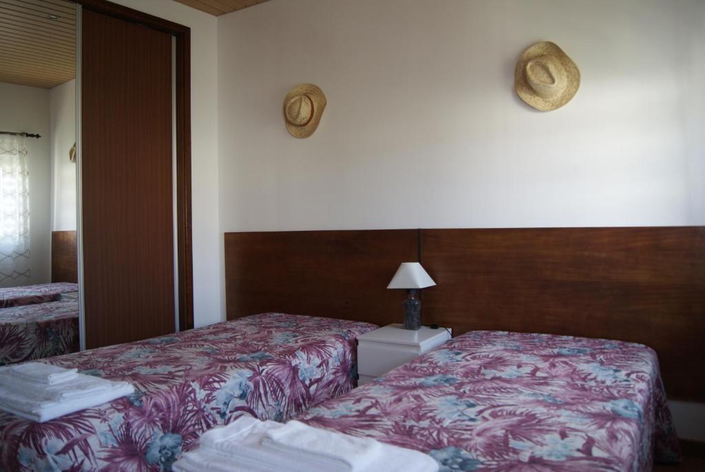 a hotel room with two beds and a mirror at LG STAY in Castro Daire