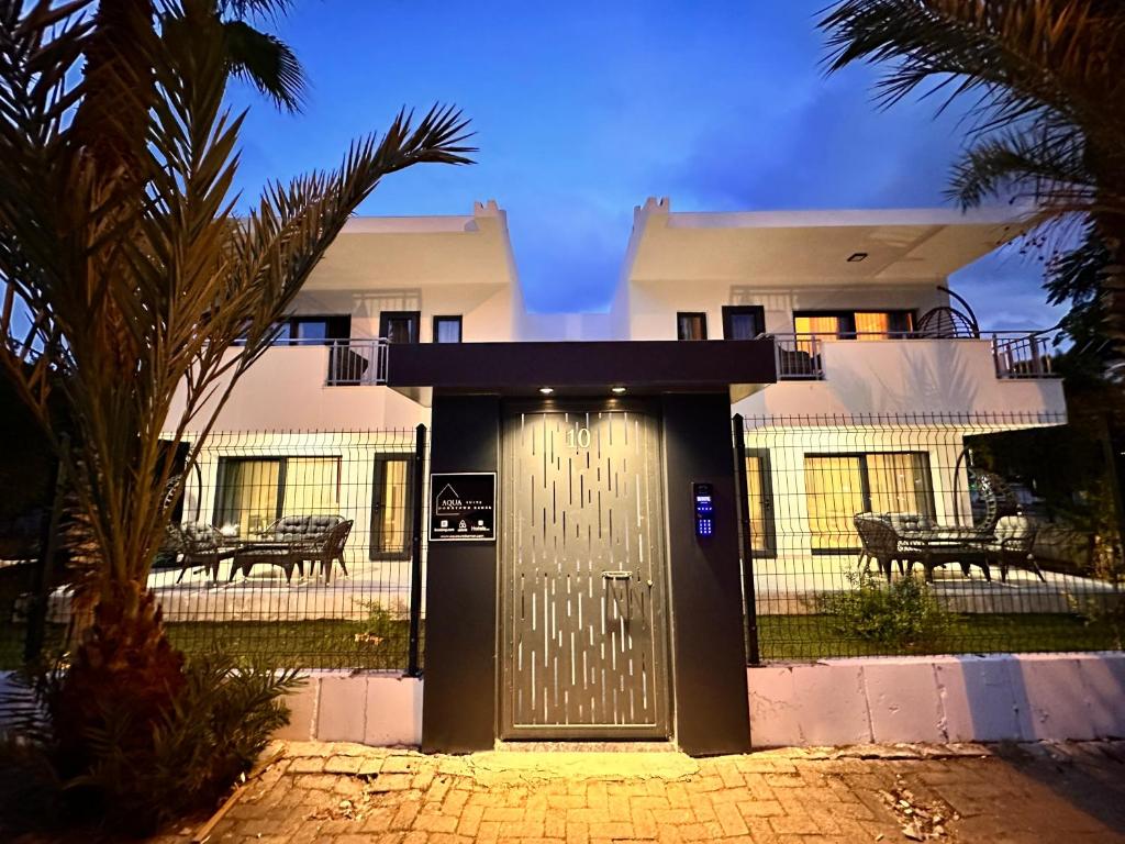 a house with a metal door in front of it at AQUA Suite Kemer in Kemer