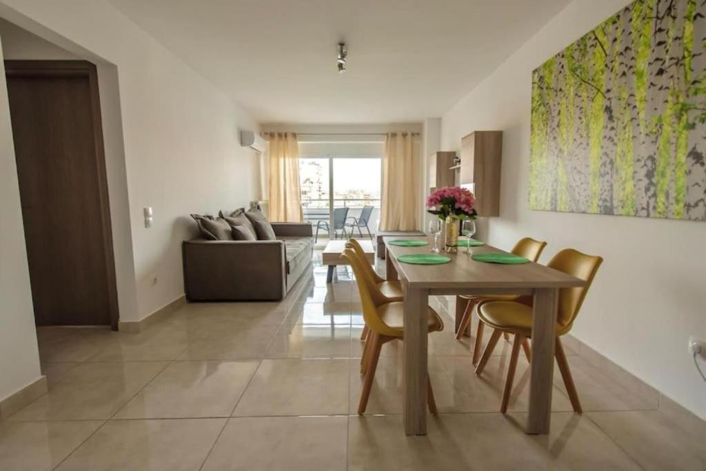 a dining room and living room with a table and chairs at Cozy 2-bedroom Apartment in Piraeus (ERM_E9) in Piraeus