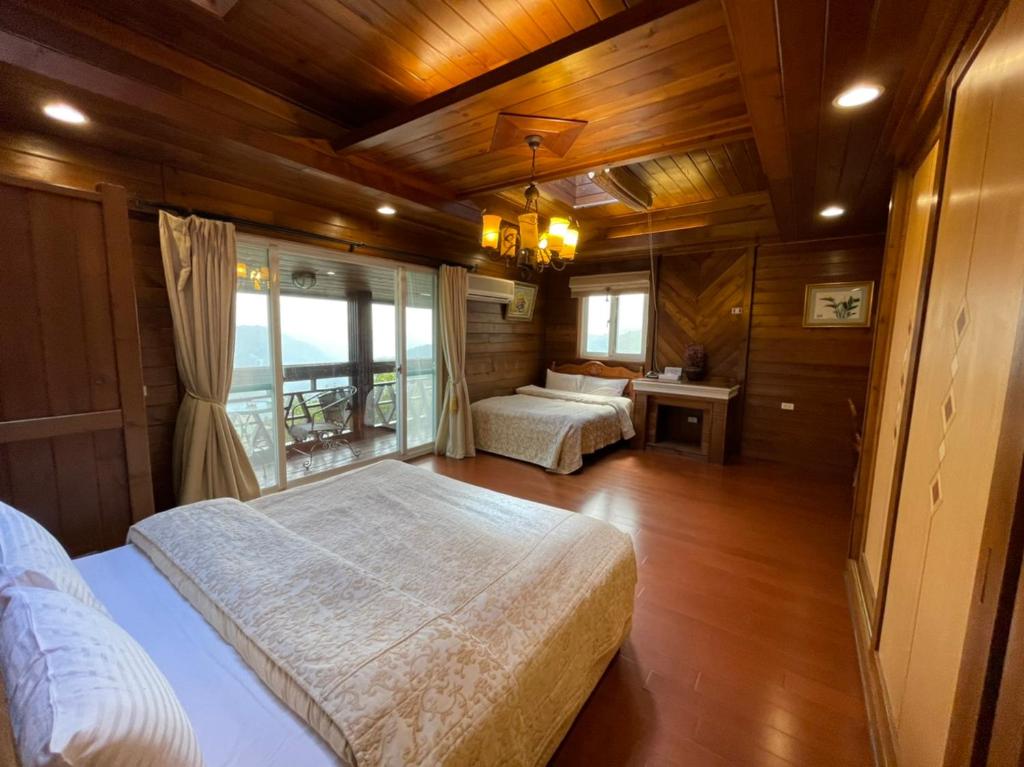 a bedroom with two beds and a window at Emmanuel Farm House in Ren&#39;ai