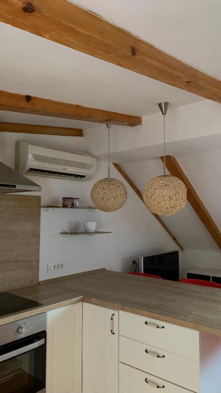 a kitchen with two lights hanging from the ceiling at Le Liv On in Rijeka